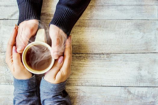 Cup drink for Breakfast in the hands of lovers. Selective focus. Nature.