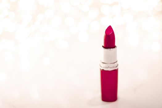 Cosmetic branding, sale and glamour concept - Maroon lipstick on golden Christmas, New Years and Valentines Day holiday glitter background, make-up and cosmetics product for luxury beauty brand