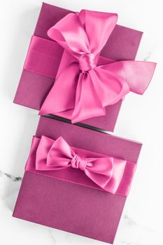 Birthday, wedding and girly branding concept - Pink gift box with silk bow on marble background, girl baby shower present and glamour fashion gift for luxury beauty brand, holiday flatlay art design