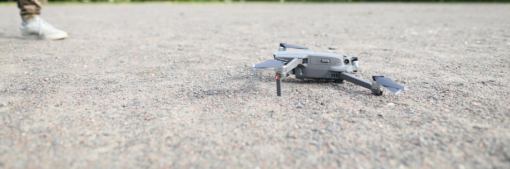 Small digital drone stands on ground. Start service on earth concept