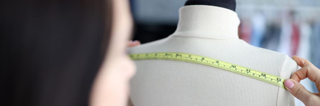 Woman fashion designer takes measurements with centimeter. Sewing clothes collection concept