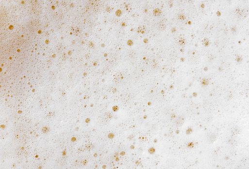 Beer foam top view. Soft fresh Foam on light beer. Bubble froth of beer. Beer foam texture background.