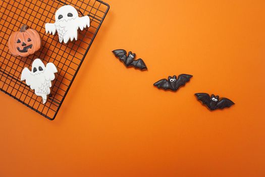 Halloween gingerbread cookies are on an orange background. High quality photo