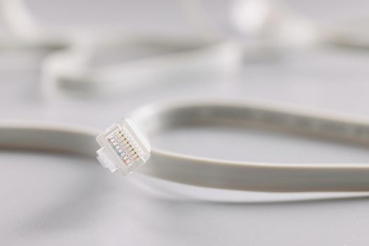 Ethernet LAN carrier and cable on a gray background, close-up. Cables and connectors used for data transmission