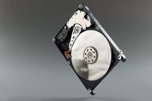 New hard drive a gray background, close-up. Computer memory, spare part, pc upgrade, hdd system, hardware