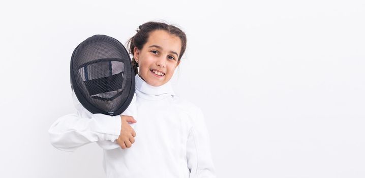 Little girl fencer with epee and mask.