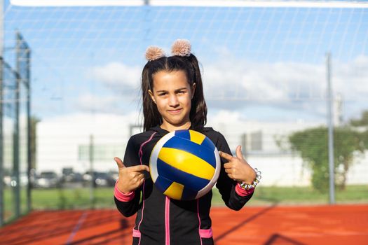 little girl with a volleyball ball.