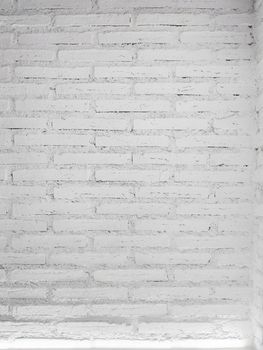 White brick wall background with a light. vertical size.