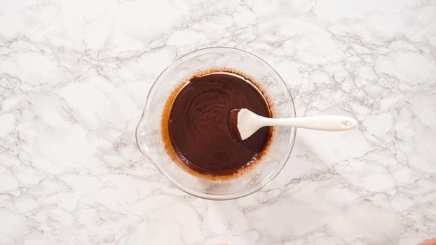 Flat lay. Step by step. Preparing chocolate ganache in a glass mixing bowl.