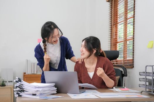 Female smiling colleagues celebrate business win, goal achievement at workplace, giving five, successful teamwork, businesswomen start work with new project, good brainstorm results, victory concept.