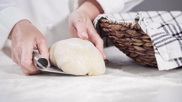 Knitting dough by hand to bake cinnamon rolls.