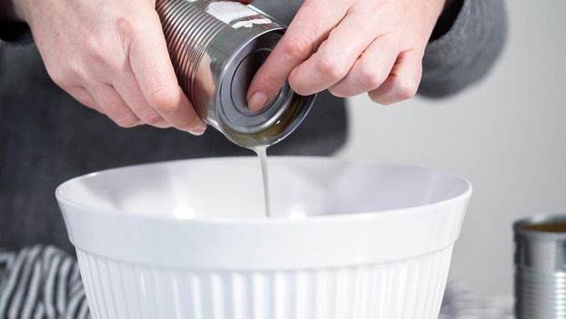 Openning canned white beans with can opener.