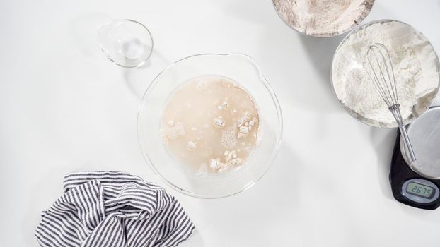 Flat lay. Measuring ingredients into a glass bowl to bake cinnamon rolls.