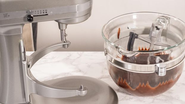 Step by step. Whipping chocolate ganache with an electric kitchen mixer.
