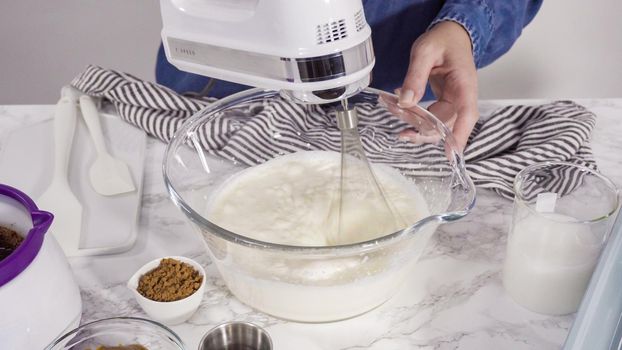 Step by step. Preparing homemade chocolate ice cream in a hand kitchen mixer.