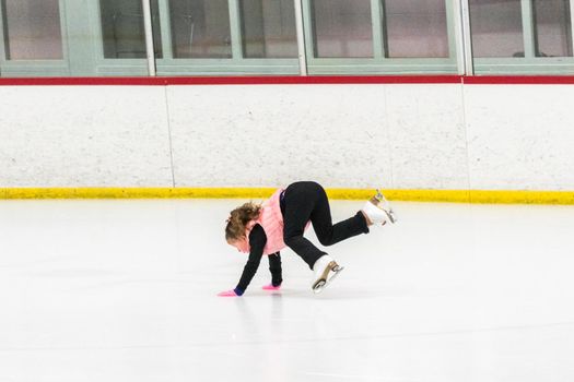 Little skater practicing her elements at the morning figure skating practice.