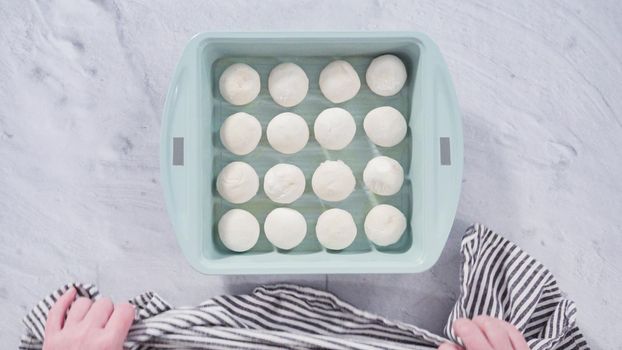Flat lay. Preparing dinner rolls from the frozen dough in baking pan.
