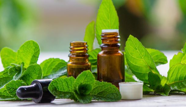 The mint extract in a small jar. Selective focus.