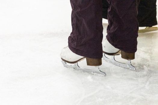 View of a figure skater and her coach feet at the figure skating practice.