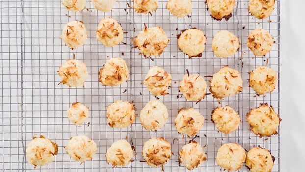 Flat lay. Cooling freshly baked coconut cookies on a kitchen drying rack.