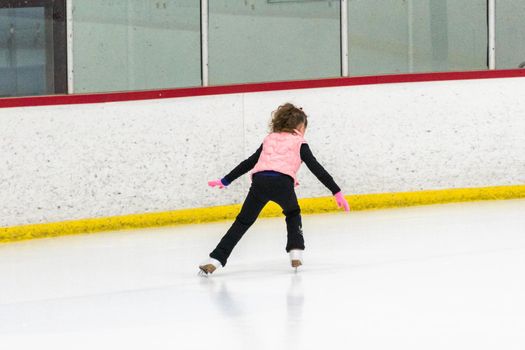 Little skater practicing her elements at the morning figure skating practice.