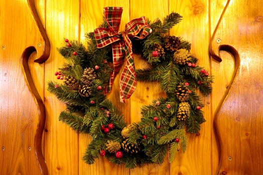 A beautiful Christmas wreath hangs on the front door
