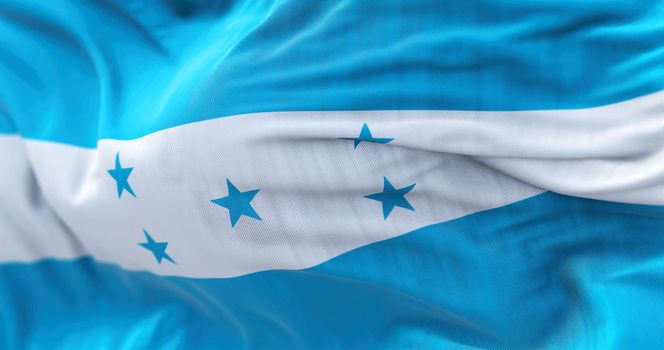 Close-up view of the Honduras national flag waving in the wind. The Republic of Honduras is a state of Central America. Fabric textured background. Selective focus