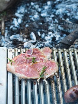 cooking pork meat in the grill outdoors with charcoal