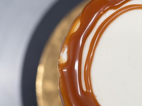 professional baker decorating a chocolate and cream cake with salty caramel
