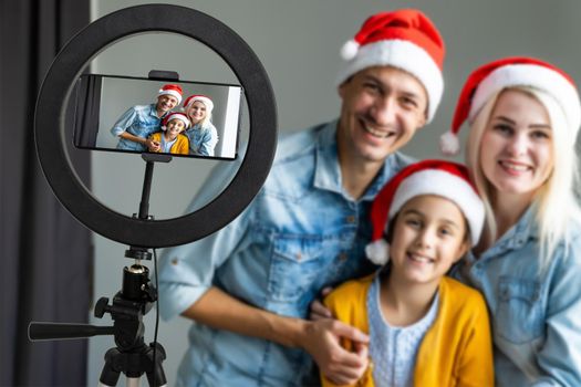 Photo of cheerful family happy positive smile make selfie record video enjoy time together sit couch indoors