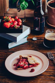 Portion of Strawberry and Sorrel Galette on Plate with Glass of Stout