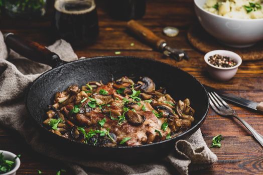 Fried pork neck steak with different mushrooms cast iron pan