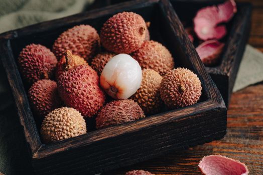 Small Box of Lychees on Wooden Table