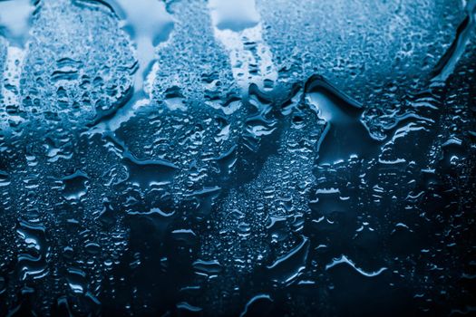 Liquid, wet and zen concept - Water texture abstract background, aqua drops on blue glass as science macro element, rainy weather and nature surface art backdrop for environmental brand design
