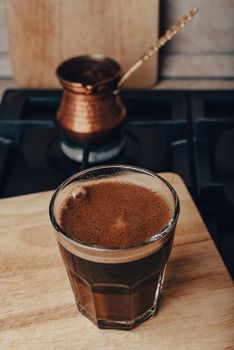 Glass of Hot Coffee Prepared in Copper Jezve