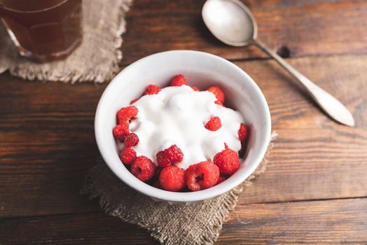 Healthy Dessert with Fresh Raspberries and Greek Yogurt in Bowl on Rustic Table