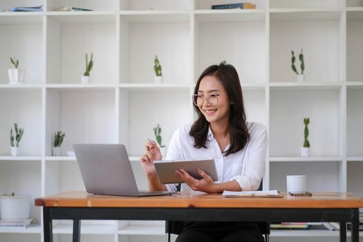 Beautiful woman Asian using digital tablet work at the office..