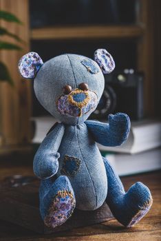 Blue Handmade Bear Toy Sitting on Wooden Surface