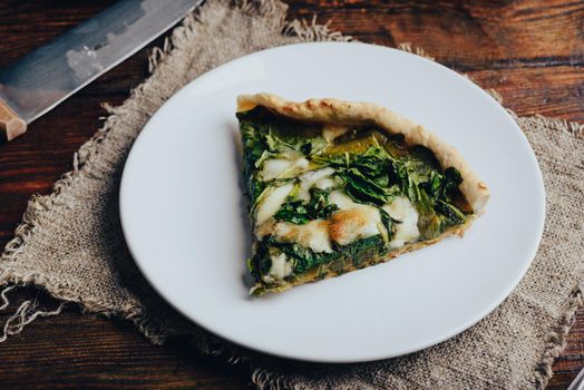 Slice of Galette Pie with Spinach and Mozzarella Cheese on White Plate