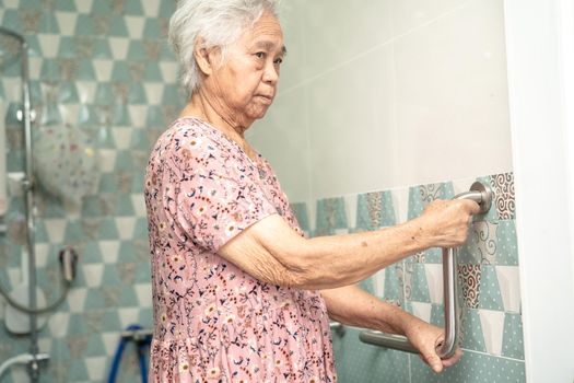 Asian senior or elderly old lady woman patient use toilet bathroom handle security in nursing hospital ward, healthy strong medical concept.