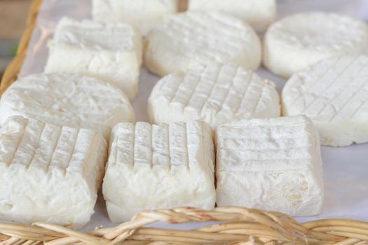 fresh goat homemade cheese at the market, closeup photo