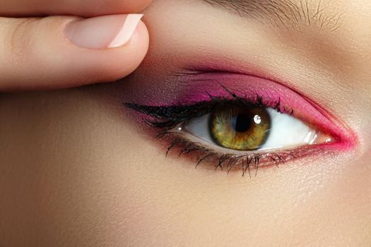 Closeup Macro of Woman Face with Pink Eyes Make-up. Fashion Celebrate Makeup, Glowy Clean Skin. Beautiful Bright Magenta Red Make-up. Eyelid lift Cosmetology and Blepharoplasty