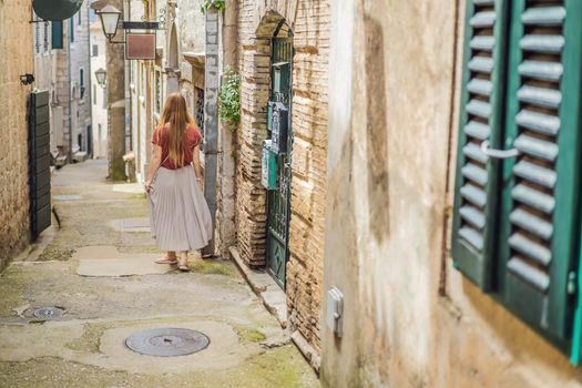 Woman tourist in Herceg Novi old town. Historical and touristic center of Herceg Novi. Montenegro.