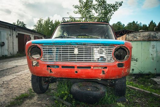 an old broken classic car abandoned on the street. stainless old machine. retro car closeup. High quality photo