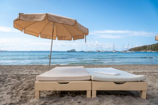 Bed and umbrella in a beach bar of Ses Salines in Ibiza