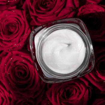 Luxe cosmetics, branding and anti-age concept - Face cream skin moisturizer and red roses flowers, luxury skincare cosmetic product on floral background as beauty brand holiday flatlay design