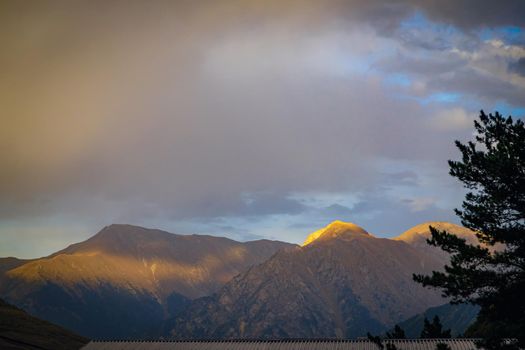 Sunset in the mountains. Rays fall on the mountains