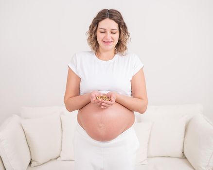 Pregnant woman holding a handful of walnuts