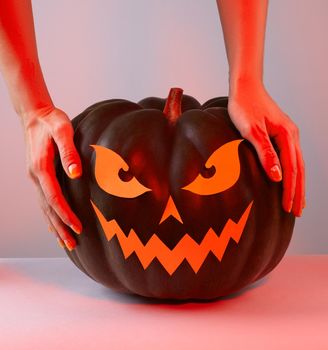 Halloween Pumpkin with Paper Cut Scary Face in trend red and orange colors. Jack Halloween. Smile Jack Pumpkin
