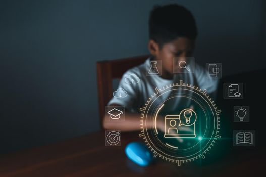 education icon On the background of blurry pictures a boy is staring at a computer monitor. educational concept, educational information search, copy space